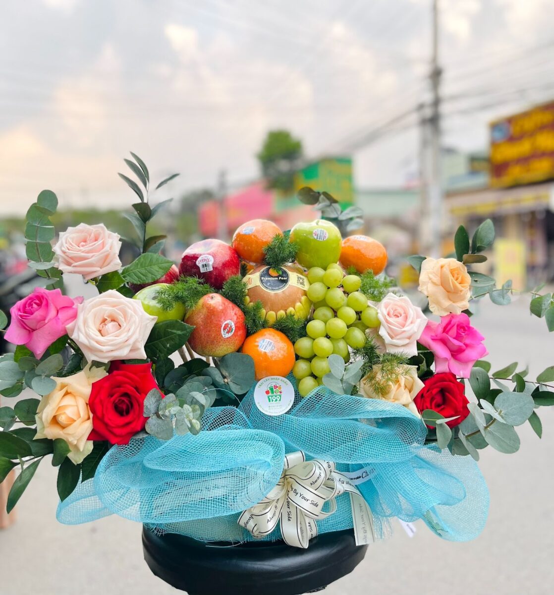 A gift basket using imported fruit and flowers from Da Lat, Vietnam